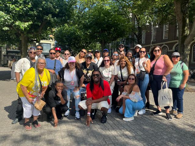Large tour group photo in an Amsterdam square