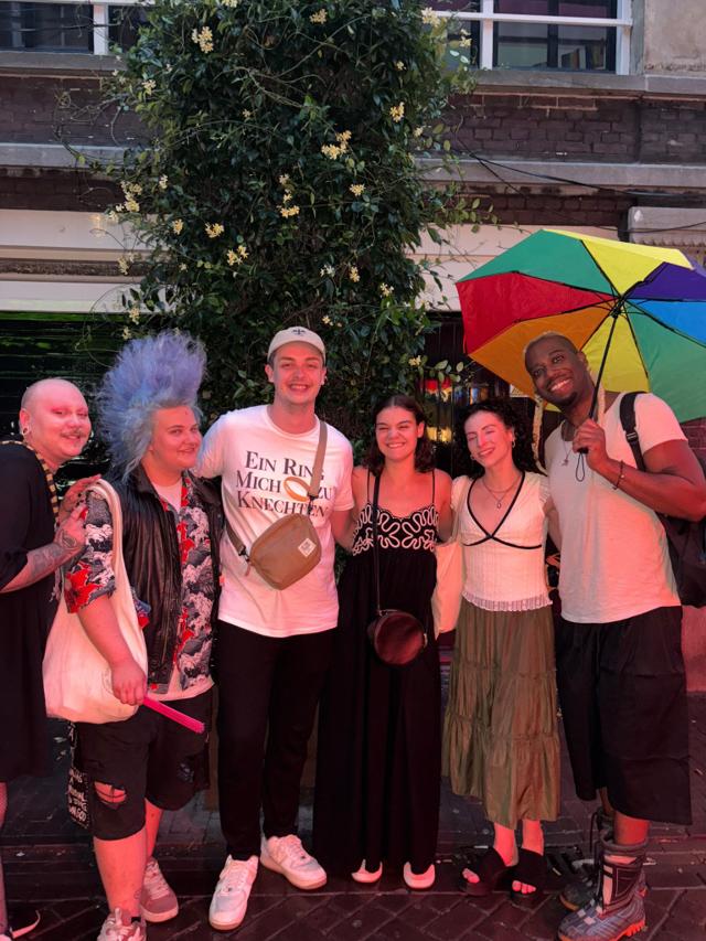 Small group with a rainbow umbrella in Amsterdam
