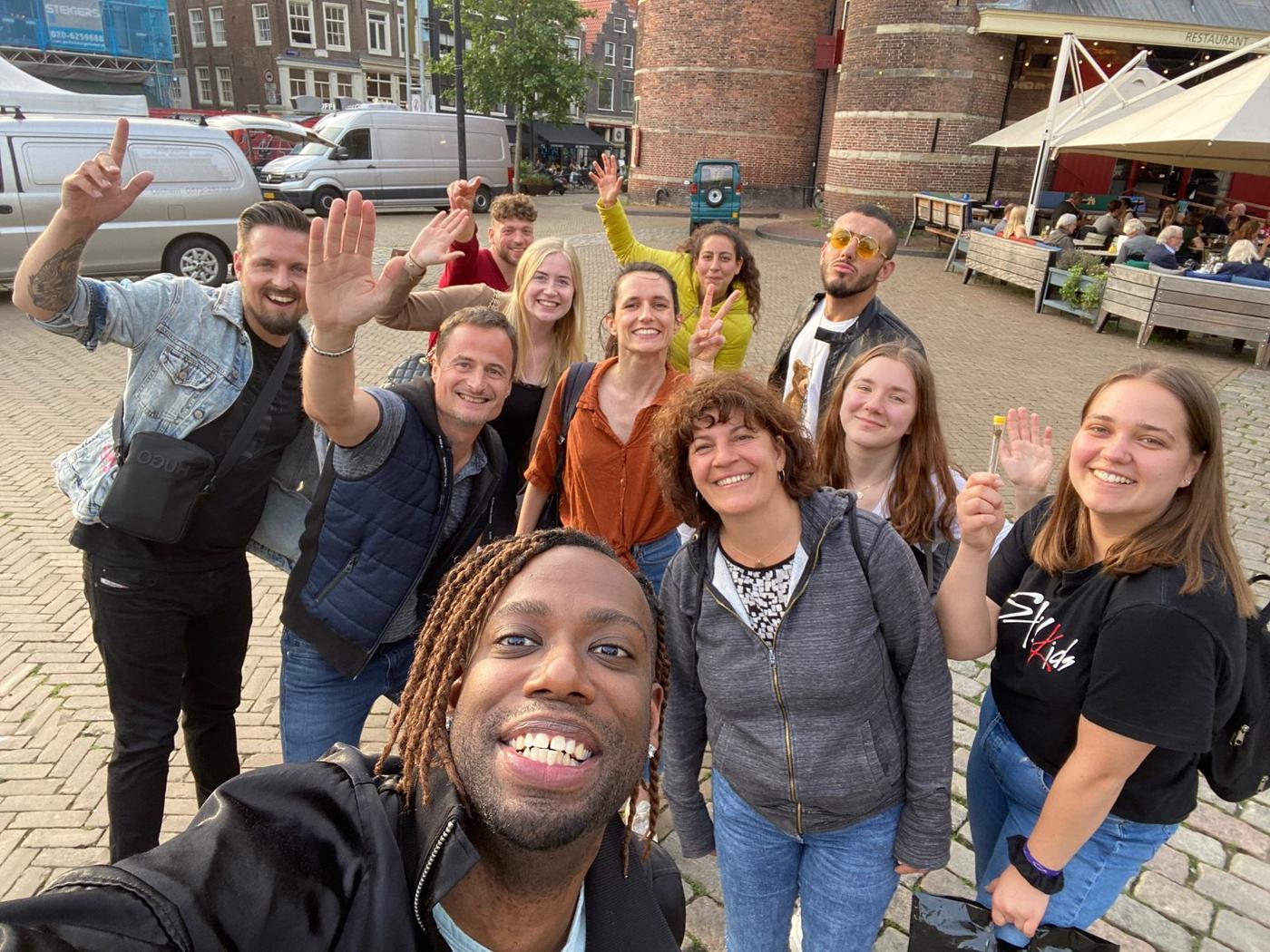 Oranje Umbrella tour group in front of De Waag, the fifteenth-century former city gate on Nieuwmarkt